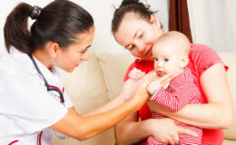 Pediatrician checking a baby