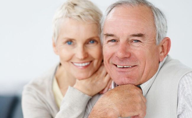 Charming old couple smiling together